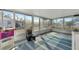 Bright screened porch with striped rug and storage at 5806 15Th W St, Bradenton, FL 34207