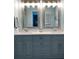 Double vanity bathroom with gray cabinets and updated lighting at 6707 Stone River Rd # 203, Bradenton, FL 34203