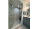 Bathroom with shower stall, gray vanity, and modern fixtures at 6707 Stone River Rd # 203, Bradenton, FL 34203