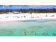Aerial view of a beach with clear water and people at 6707 Stone River Rd # 203, Bradenton, FL 34203