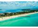 Aerial view of a beach with pier and turquoise water at 6707 Stone River Rd # 203, Bradenton, FL 34203