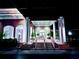 Elegant clubhouse entrance with columns at night at 6707 Stone River Rd # 203, Bradenton, FL 34203
