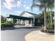 Clubhouse exterior with green awning and landscaping at 6707 Stone River Rd # 203, Bradenton, FL 34203