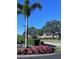 Landscaped entrance to community with flowers at 6707 Stone River Rd # 203, Bradenton, FL 34203