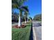 Landscaped entrance with palm trees and flowers at 6707 Stone River Rd # 203, Bradenton, FL 34203