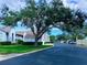 Community view with lush landscaping and parking at 6707 Stone River Rd # 203, Bradenton, FL 34203