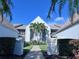 Front entrance and walkway of a light blue condo building with palm trees at 6707 Stone River Rd # 203, Bradenton, FL 34203