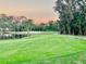 Golf course with pond and palm trees at sunset at 6707 Stone River Rd # 203, Bradenton, FL 34203
