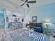 Open concept living and dining area with light blue walls and wood-look floors at 6707 Stone River Rd # 203, Bradenton, FL 34203