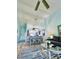 Open concept living and dining area with light blue walls and wood-look floors at 6707 Stone River Rd # 203, Bradenton, FL 34203