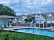Community pool with lounge chairs and covered seating at 6707 Stone River Rd # 203, Bradenton, FL 34203
