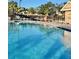 Sparkling community pool with surrounding lounge chairs at 6707 Stone River Rd # 203, Bradenton, FL 34203