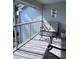 Relaxing screened balcony with seating and glass top table at 6707 Stone River Rd # 203, Bradenton, FL 34203