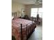 Cozy bedroom with a floral bedspread and a window offering natural light at 7030 W Country Club N Dr # 128, Sarasota, FL 34243
