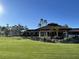 Landscaped grounds with palm trees and a clubhouse entrance at 7030 W Country Club N Dr # 128, Sarasota, FL 34243