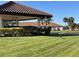 Spanish-style clubhouse with red tile roof and lush landscaping at 7030 W Country Club N Dr # 128, Sarasota, FL 34243