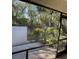 View from screened patio showing lush landscaping at 7030 W Country Club N Dr # 128, Sarasota, FL 34243