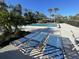 Inviting community pool with multiple lounge chairs at 7030 W Country Club N Dr # 128, Sarasota, FL 34243
