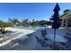 Relaxing community pool area with tables and chairs at 7030 W Country Club N Dr # 128, Sarasota, FL 34243