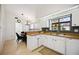 White kitchen with wood countertops, ample cabinetry, and a view of the dining area at 7361 Oak Moss Dr # 34, Sarasota, FL 34241