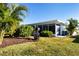 Landscaped backyard with lush greenery and screened patio at 804 Buttonwood Dr, Bradenton, FL 34208
