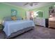 Relaxing bedroom with light green walls, a king bed, and built-in dresser at 804 Buttonwood Dr, Bradenton, FL 34208