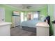 Spacious bedroom with light green walls, a king-size bed, and ample dresser space at 804 Buttonwood Dr, Bradenton, FL 34208