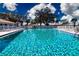 Relaxing community pool with surrounding lounge chairs at 804 Buttonwood Dr, Bradenton, FL 34208