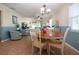 Charming dining room with wood table and chairs, adjacent to living room at 804 Buttonwood Dr, Bradenton, FL 34208