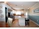 Open concept kitchen with granite countertops, stainless steel appliances, and white cabinets at 804 Buttonwood Dr, Bradenton, FL 34208