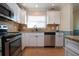 Updated kitchen with granite countertops, stainless steel appliances, and white cabinets at 804 Buttonwood Dr, Bradenton, FL 34208