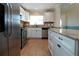 Modern kitchen with granite countertops, stainless steel appliances, and white cabinets at 804 Buttonwood Dr, Bradenton, FL 34208