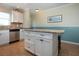 Bright kitchen features white cabinets, granite island, and stainless steel appliances at 804 Buttonwood Dr, Bradenton, FL 34208