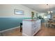 White kitchen island with granite countertop, open to dining area at 804 Buttonwood Dr, Bradenton, FL 34208