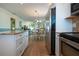 Kitchen with stainless steel appliances and granite countertops, open to dining area at 804 Buttonwood Dr, Bradenton, FL 34208