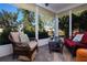 Enjoy the view from this screened porch with comfy seating and a glass-top coffee table at 804 Buttonwood Dr, Bradenton, FL 34208