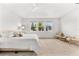 Bright bedroom with large windows, offering a tranquil view and seating area at 8725 Sundance Loop, Sarasota, FL 34238