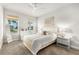 Bright bedroom with a queen bed, large windows, and neutral decor at 8725 Sundance Loop, Sarasota, FL 34238