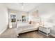 Bright bedroom with a queen bed, large windows, and neutral decor at 8725 Sundance Loop, Sarasota, FL 34238