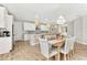 Kitchen and dining area with light wood table and patterned chairs at 8725 Sundance Loop, Sarasota, FL 34238