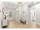 Spacious entryway with wood-look floors and a bench at 8725 Sundance Loop, Sarasota, FL 34238