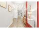 Bright entryway with wood-look floors and a red door at 8725 Sundance Loop, Sarasota, FL 34238