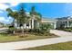 House exterior showcasing a light gray color, landscaping, and paver driveway at 8725 Sundance Loop, Sarasota, FL 34238