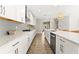 Modern kitchen with white cabinets and gray backsplash at 8725 Sundance Loop, Sarasota, FL 34238