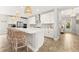 Bright kitchen features island and entryway view at 8725 Sundance Loop, Sarasota, FL 34238