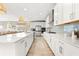 Spacious kitchen with white cabinets, stainless steel appliances, and a large island at 8725 Sundance Loop, Sarasota, FL 34238