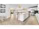 Spacious kitchen boasts modern appliances and an island with seating at 8725 Sundance Loop, Sarasota, FL 34238