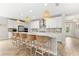Bright kitchen features an island with seating and stainless steel appliances at 8725 Sundance Loop, Sarasota, FL 34238