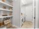 Convenient laundry room with washer, dryer, and shelving at 8725 Sundance Loop, Sarasota, FL 34238