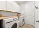 Laundry room with Samsung washer and dryer, wood countertop, and cabinets at 8725 Sundance Loop, Sarasota, FL 34238